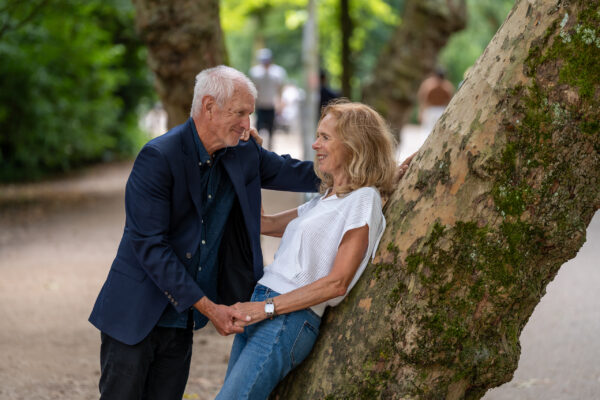 Travel portrait of couple beside a tree in Vondelpark, Amsterdam — visiting travellers shoot