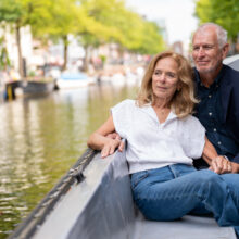 Travel portrait of couple enjoying a boatride in Amsterdam — visiting travellers shoot