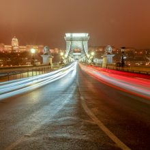A photography capturing the ambience of a foggy winter night at the Chain Bridge in Budapest.