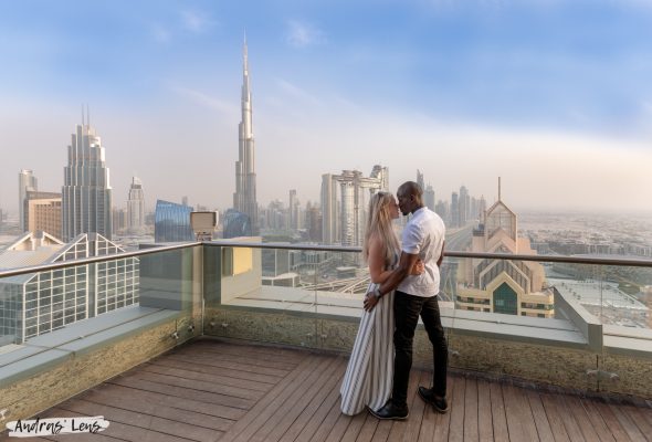 Surprise proposal on top of a skyscaper with an amazing view of the city in the background.