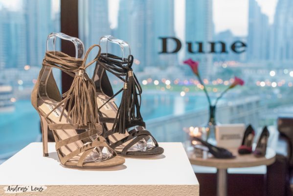 Product photography for the Dune brand portraying a pair of high heels with an overview of Downtown Amsterdam in the background.